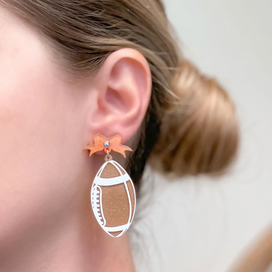 PREORDER: Football Bow Drop Earrings In Two Colors