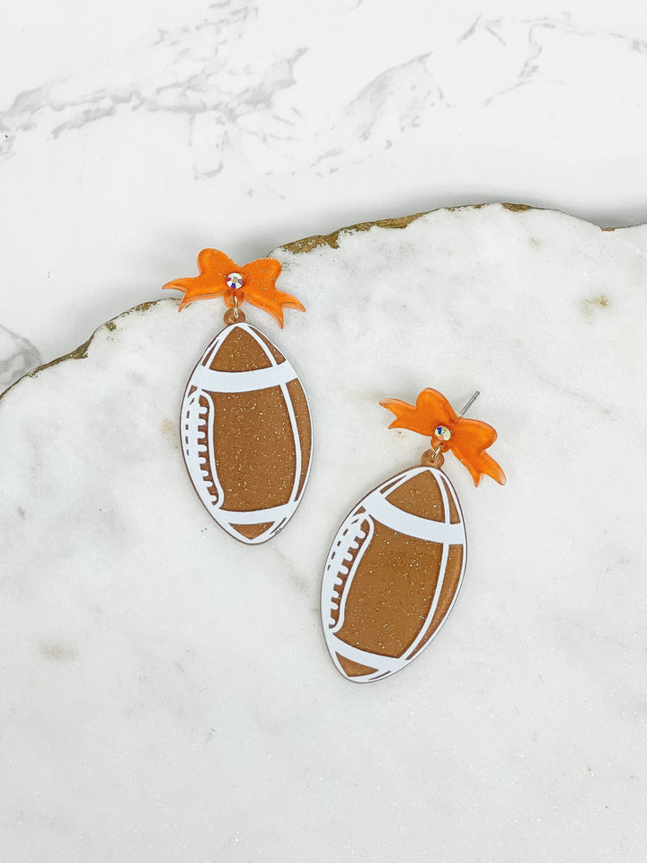 PREORDER: Football Bow Drop Earrings In Two Colors